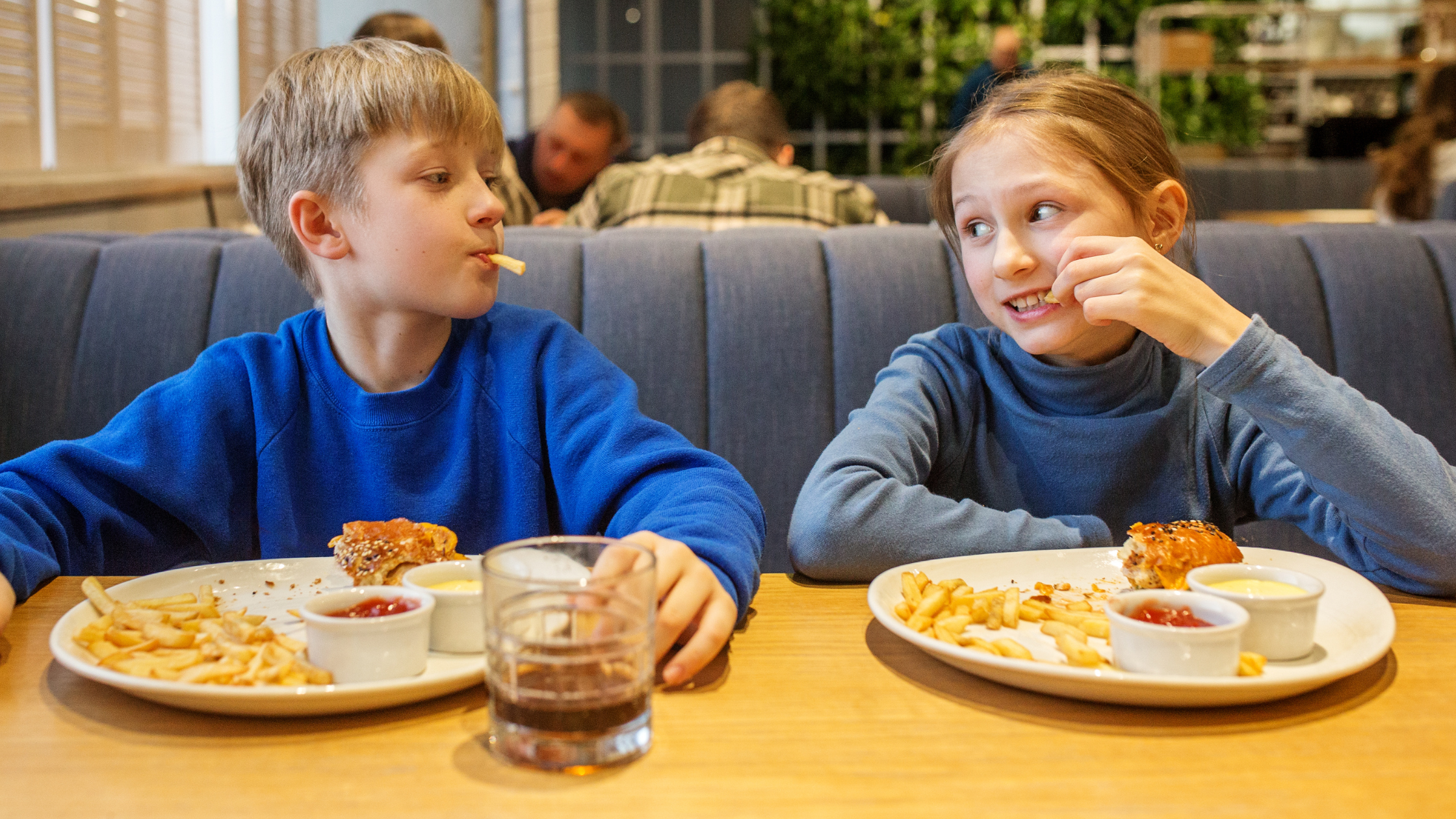 A child eating a plate full of heartburn-triggering foods